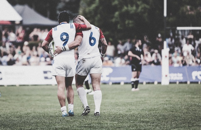 Two rugby players walking on field