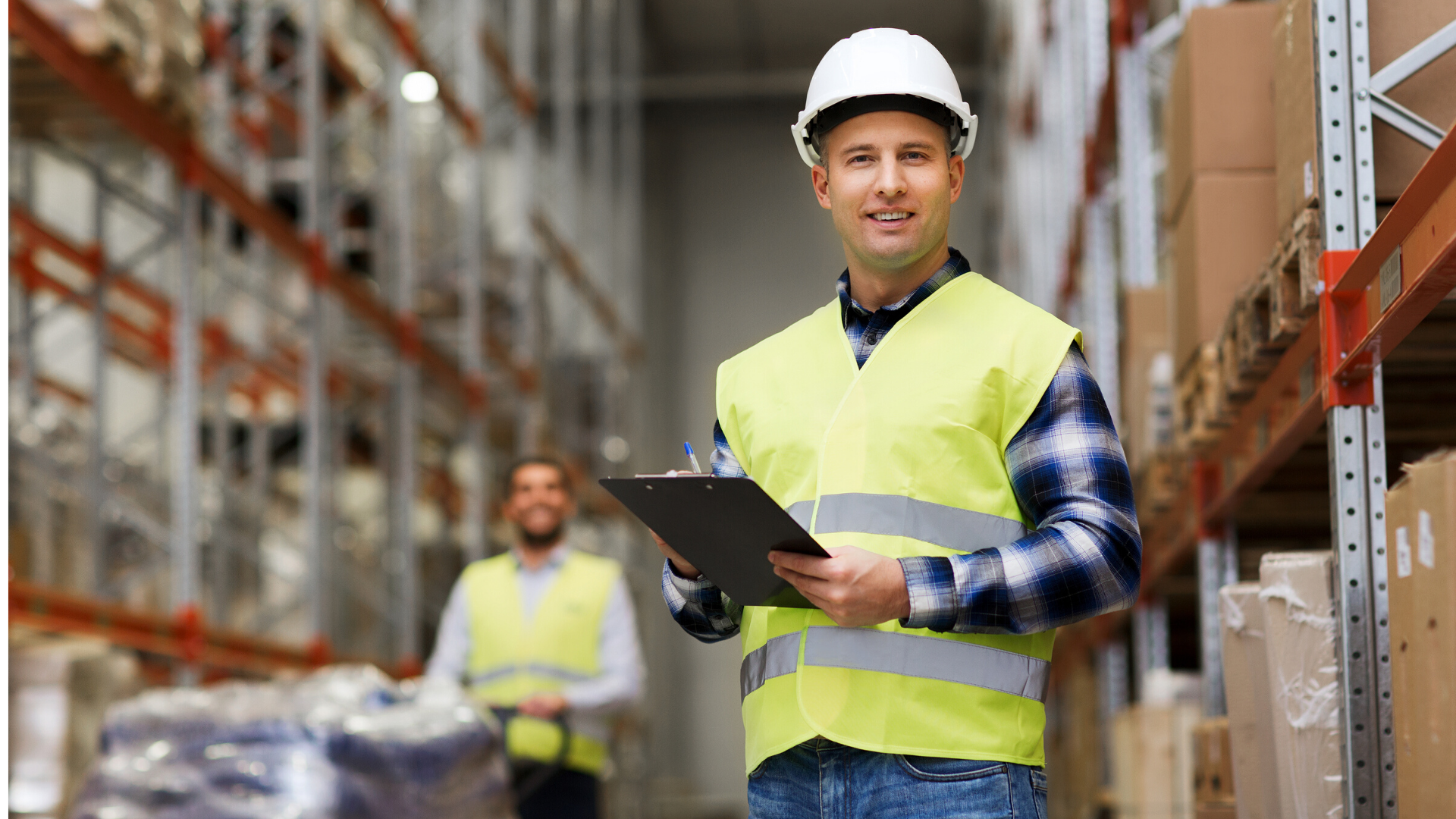 Warehouse worker wearing a vest and hard hat